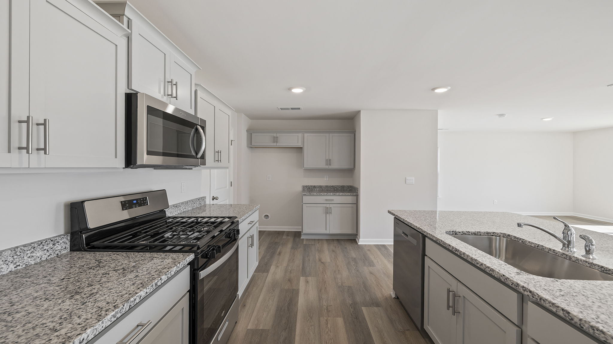 Kitchen and island with quartz countertops.