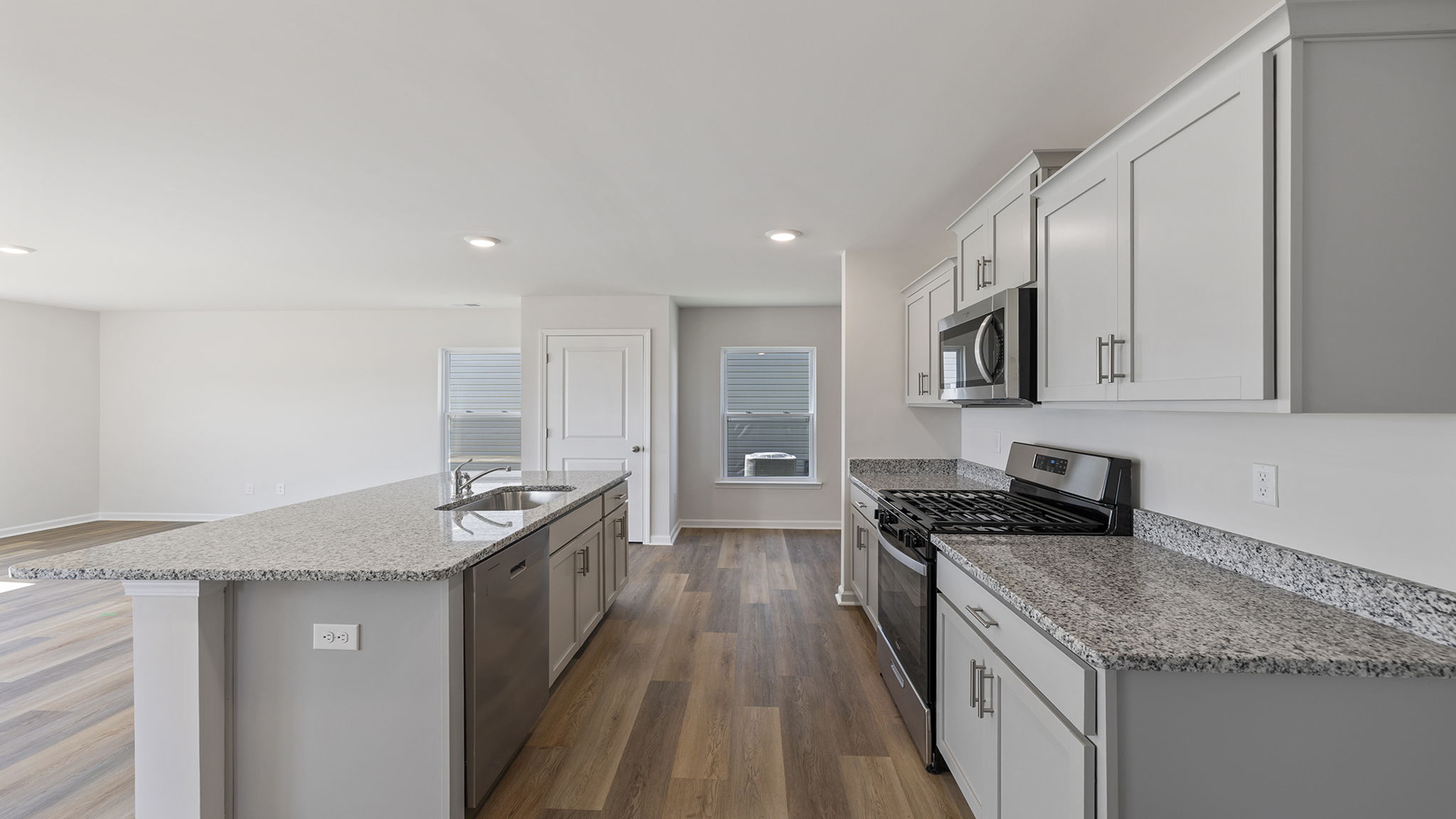 Kitchen and island with quartz countertops.