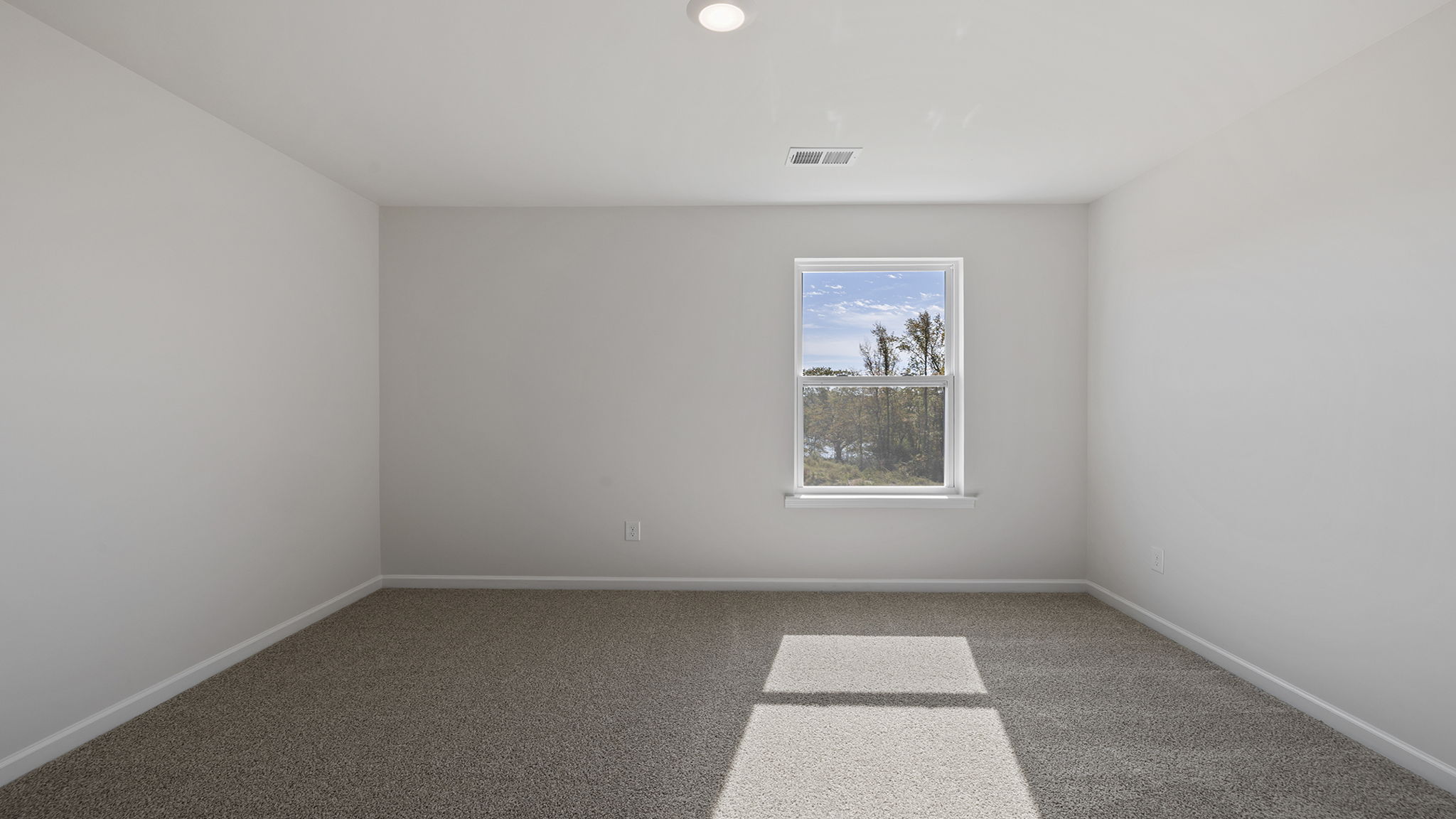 Bedroom with window and carpet.