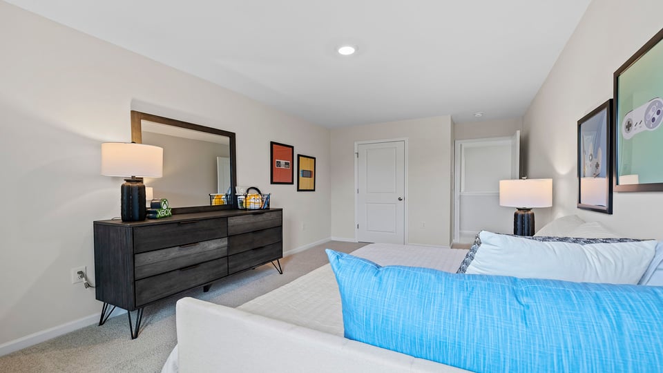 Bedroom with carpet and windows.