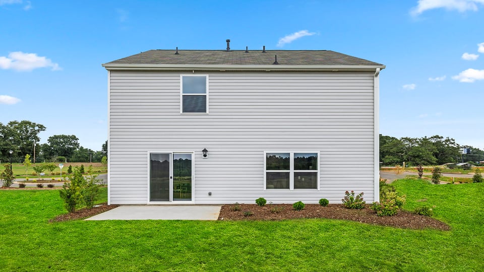 Back exterior with large backyard.