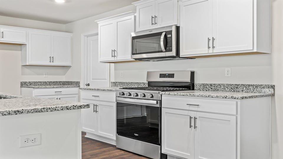 Kitchen and island with quartz countertops.