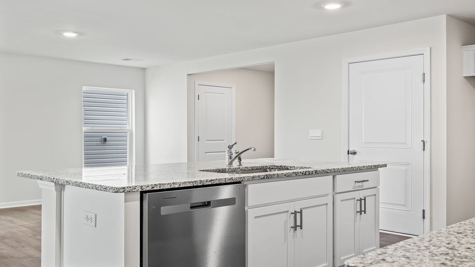 Kitchen and island with quartz countertops.
