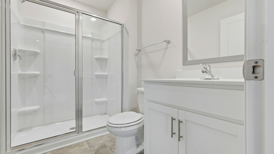 Bathroom with walk in shower and single vanity sink.