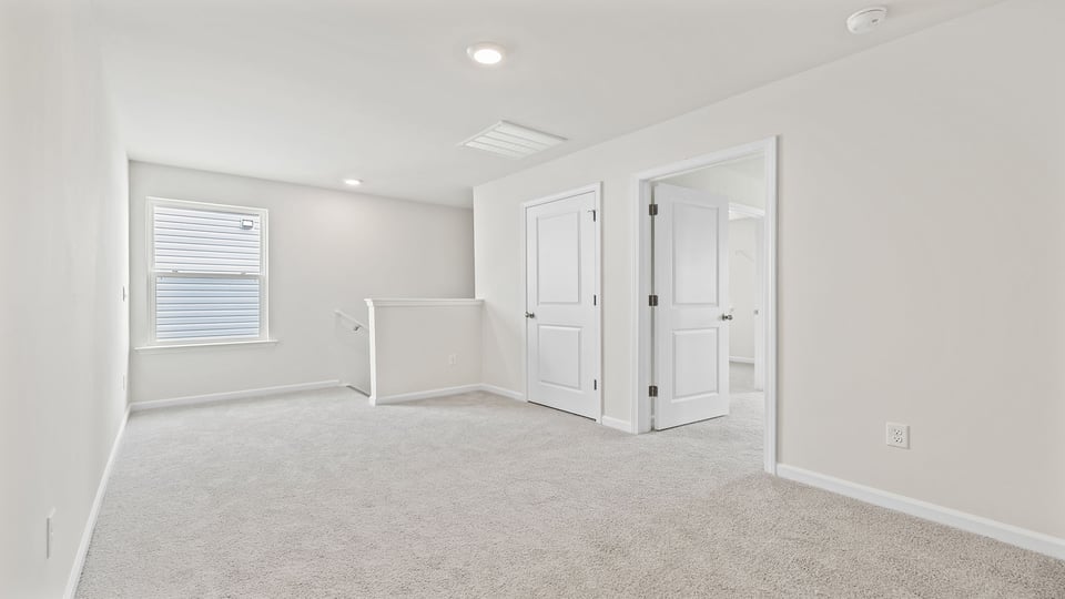 Bedroom with carpet and window.