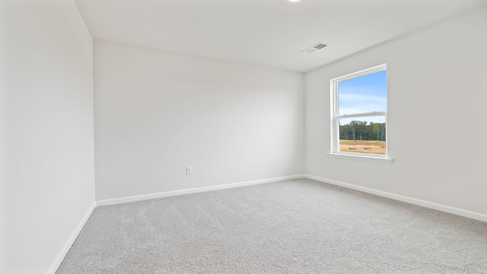 Bedroom with carpet and window.