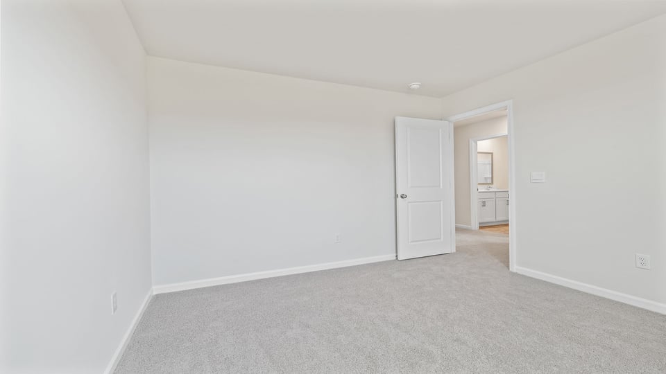 Bedroom with carpet and window.