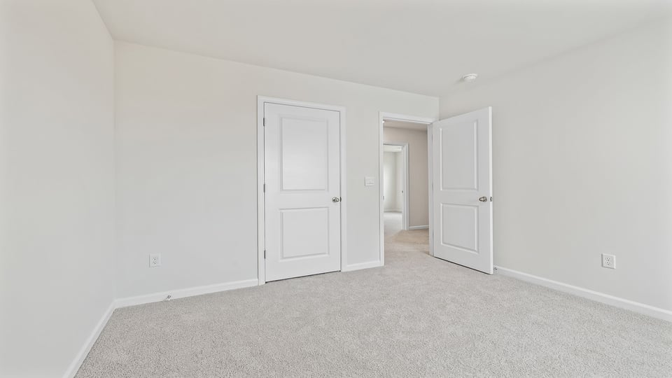 Bedroom with carpet and window.