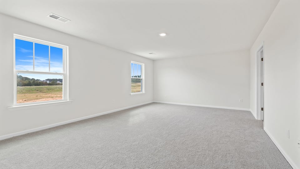 Bedroom with carpet and window.