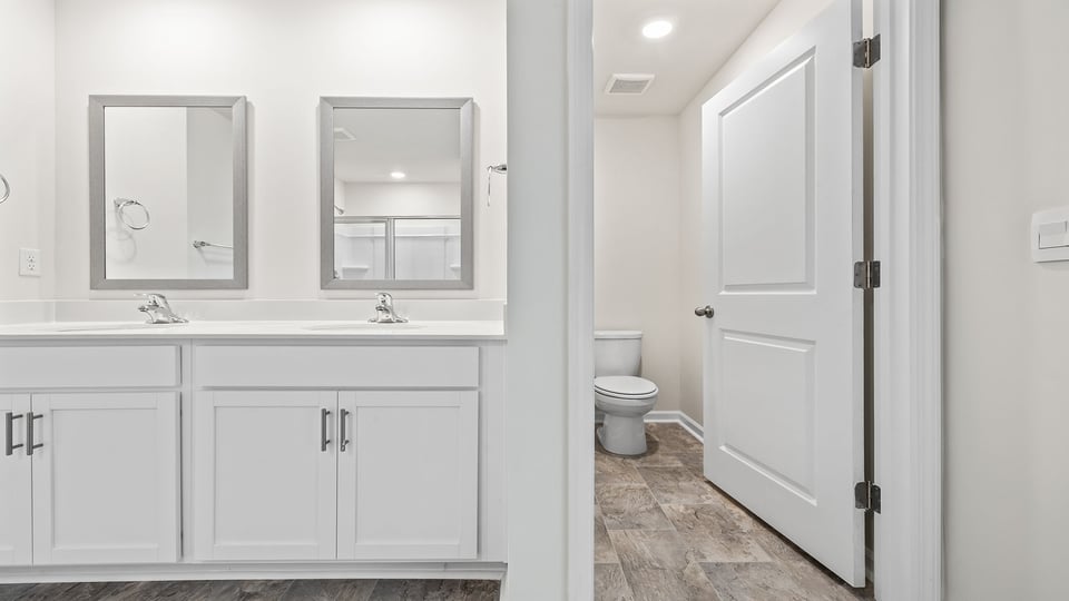 Bathroom with double vanity sink and walk in shower.