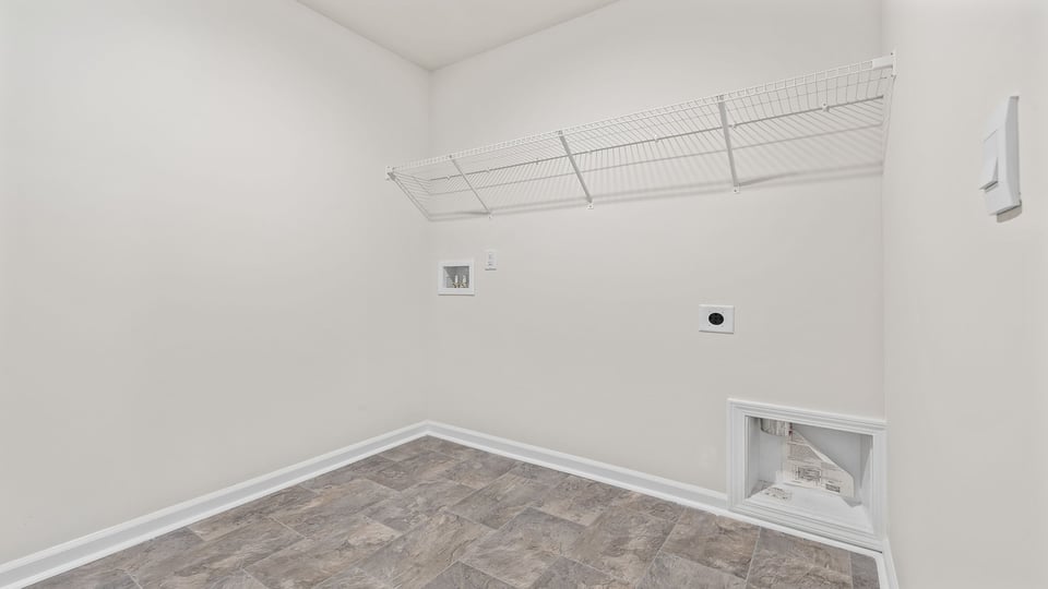 Laundry room with hanging storage racks.