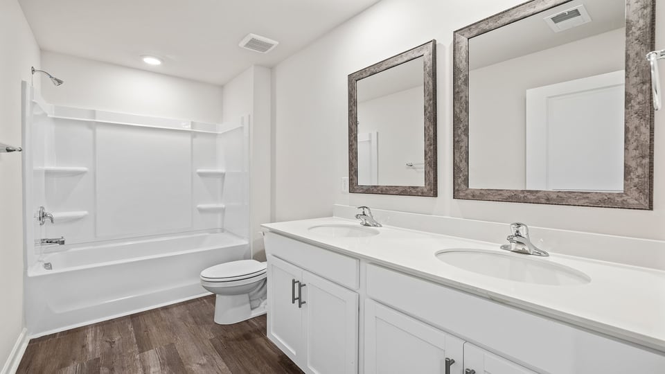 Hall bathroom with dual sink vanity.