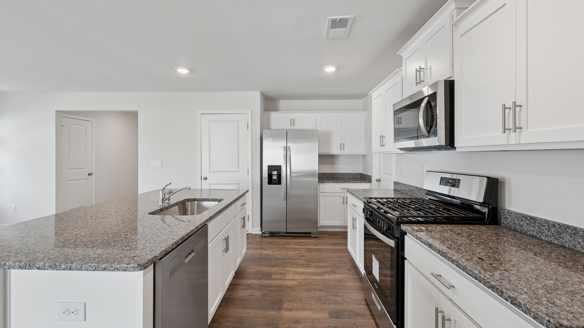 Kitchen with island and quartz countertops.