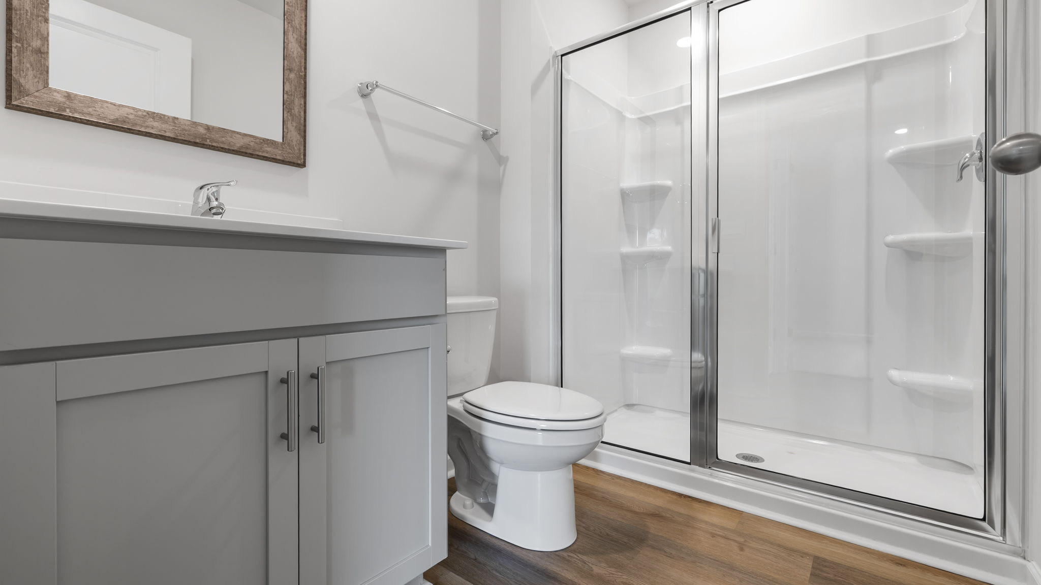 Full bathroom on main level with vanity and walk-in shower.