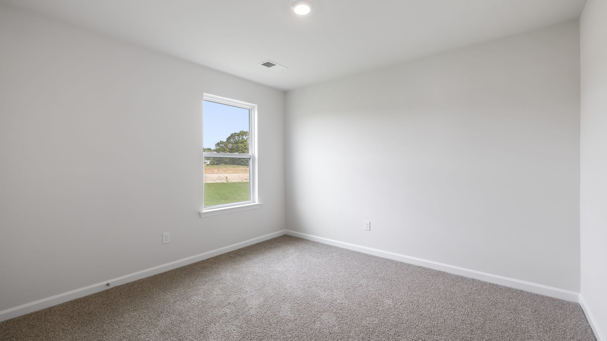 Bedroom with carpet and window.