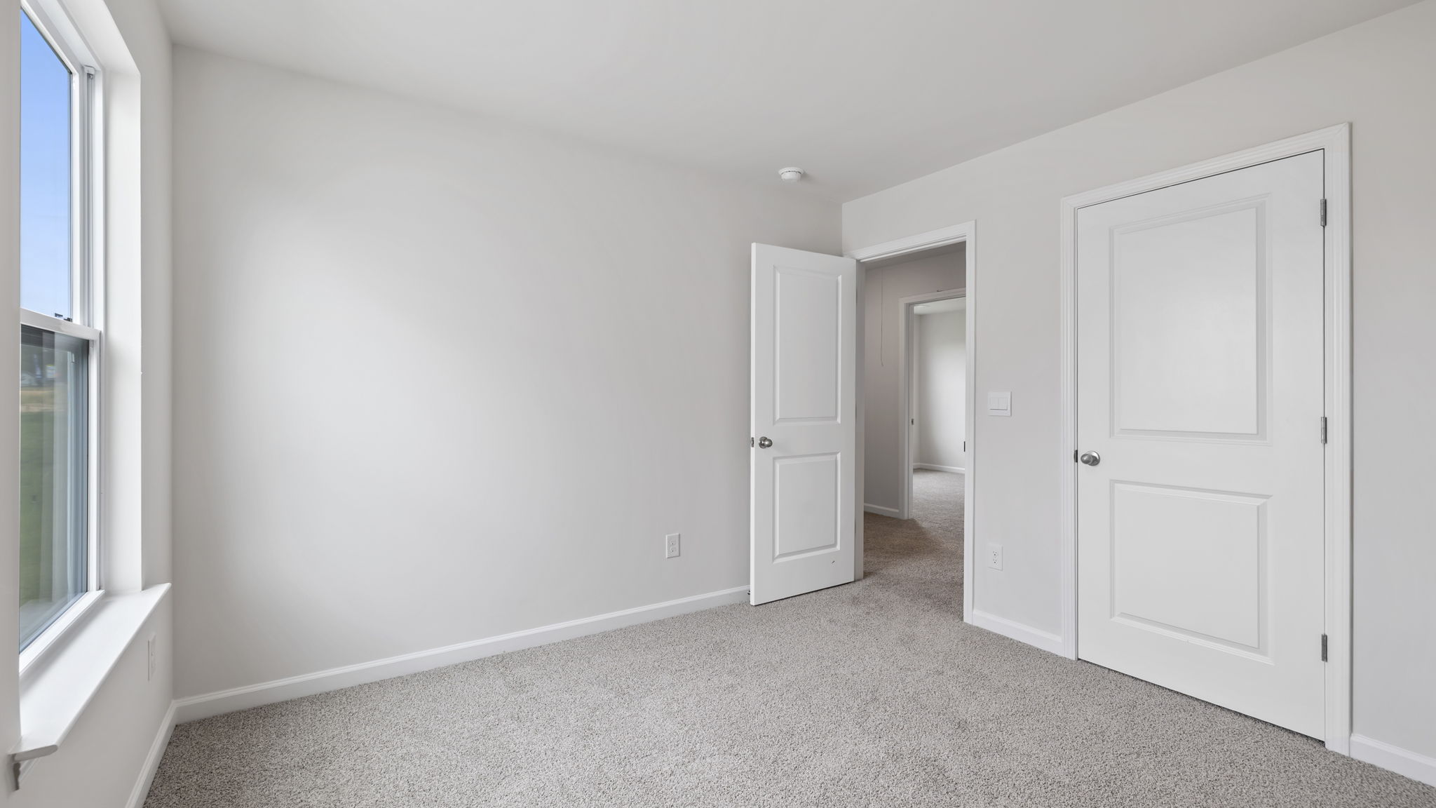 Bedroom with carpet and window.