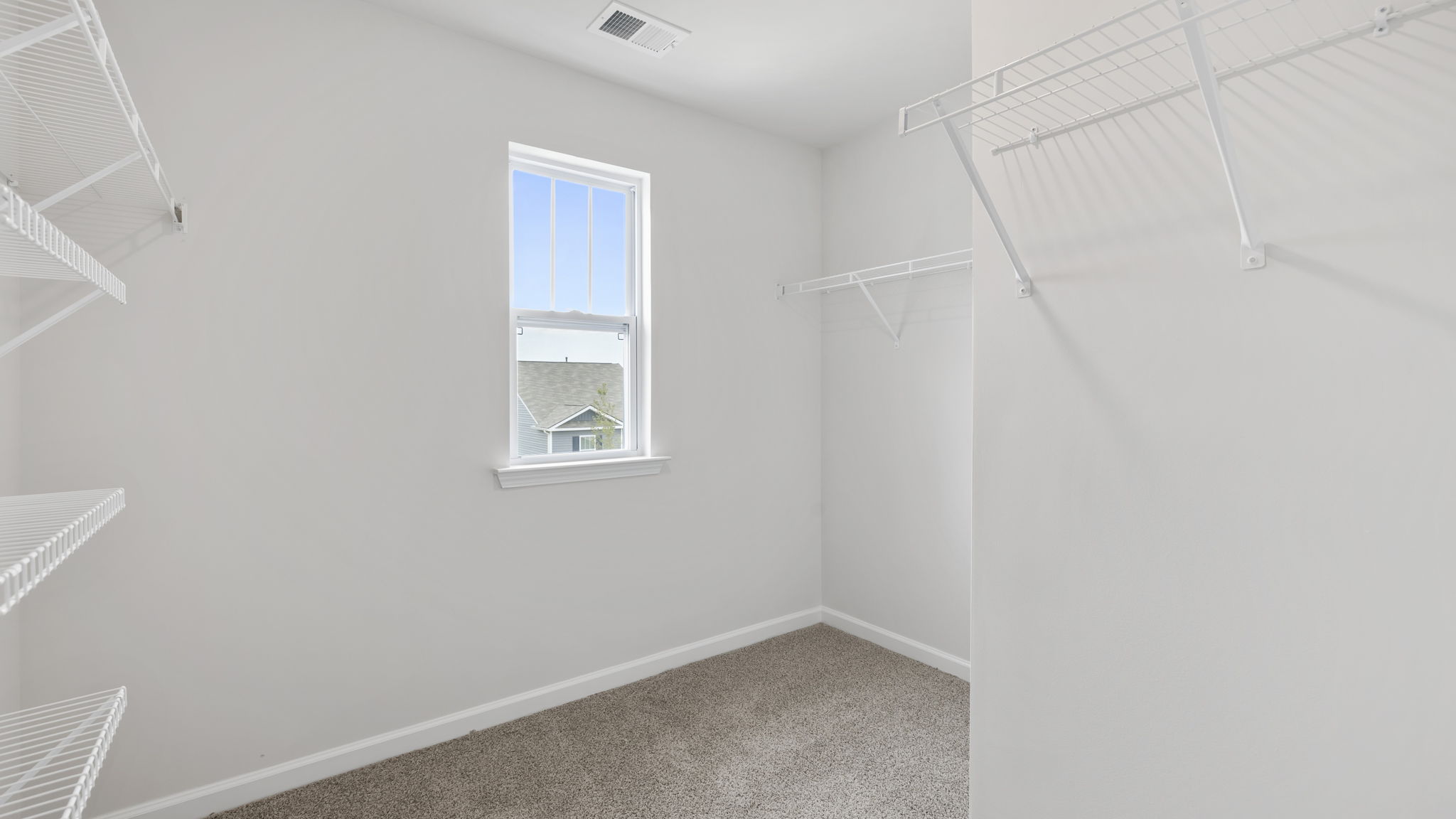Primary bedroom walk-in closet.