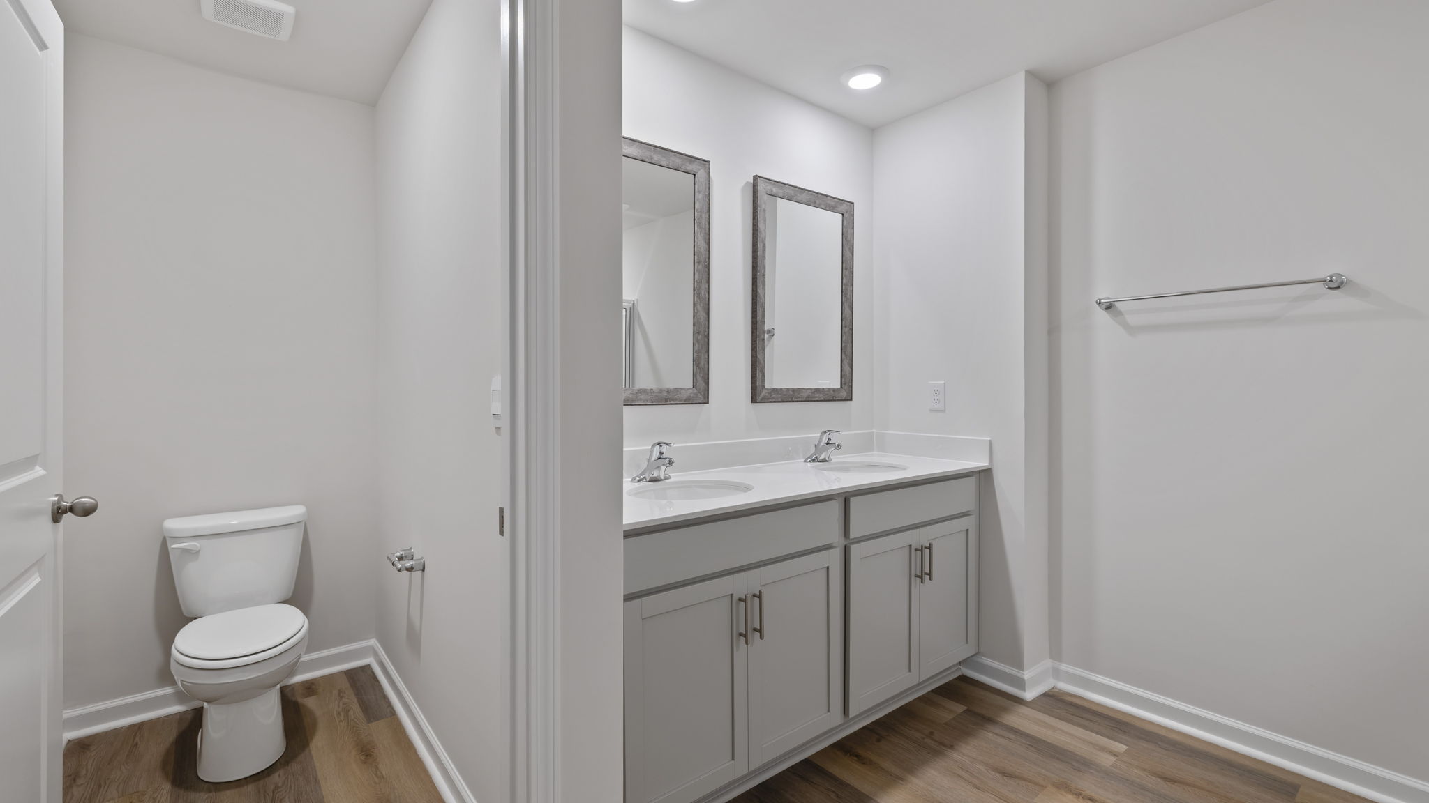 Primary bathroom with dual sink vanity and walk in shower.