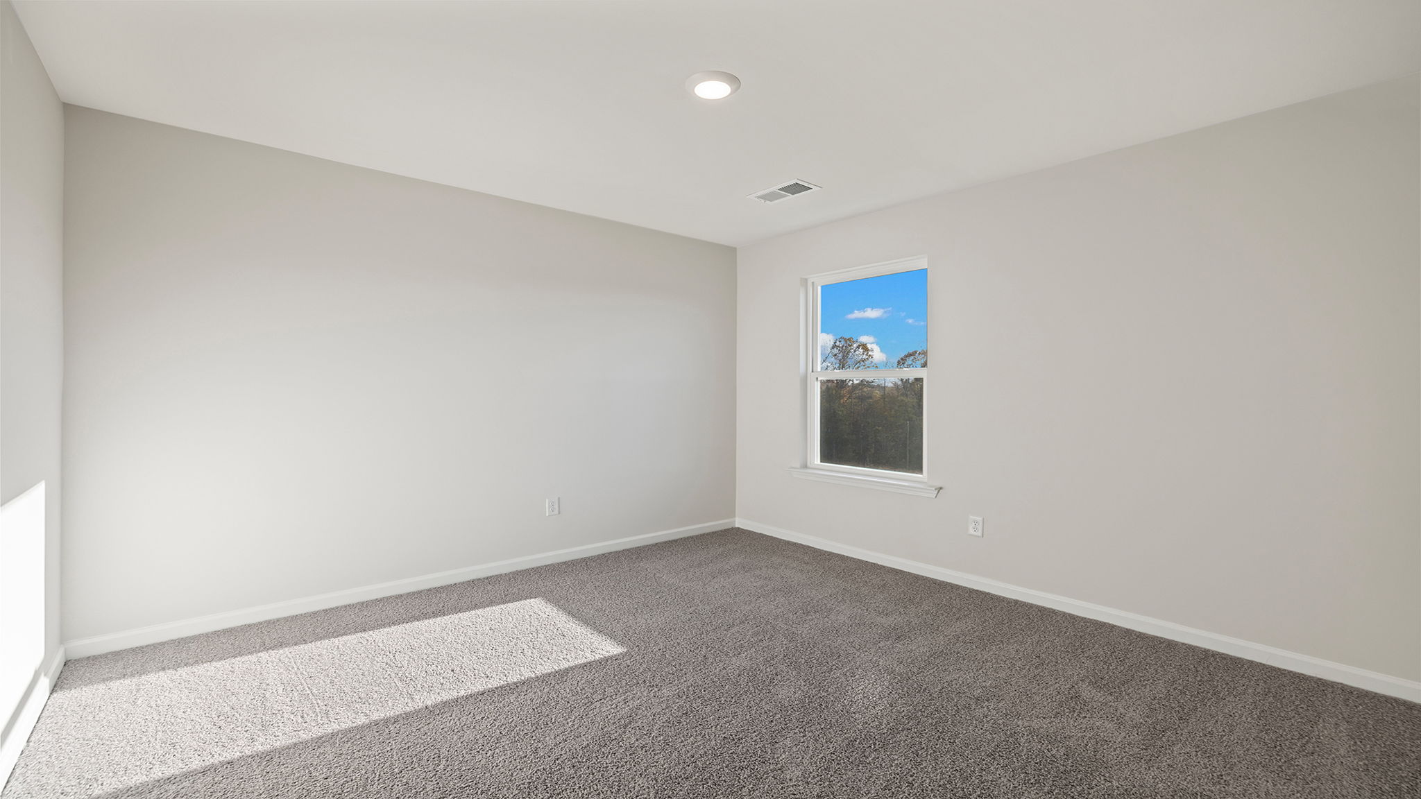 Bedroom with carpet and window.