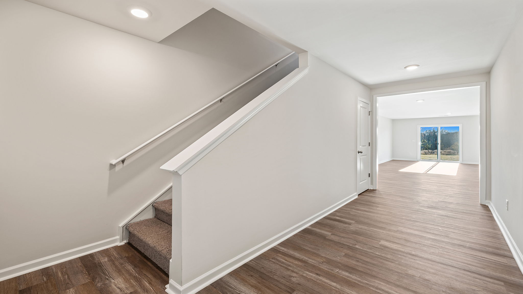 View of stairwell and hallway to family room.