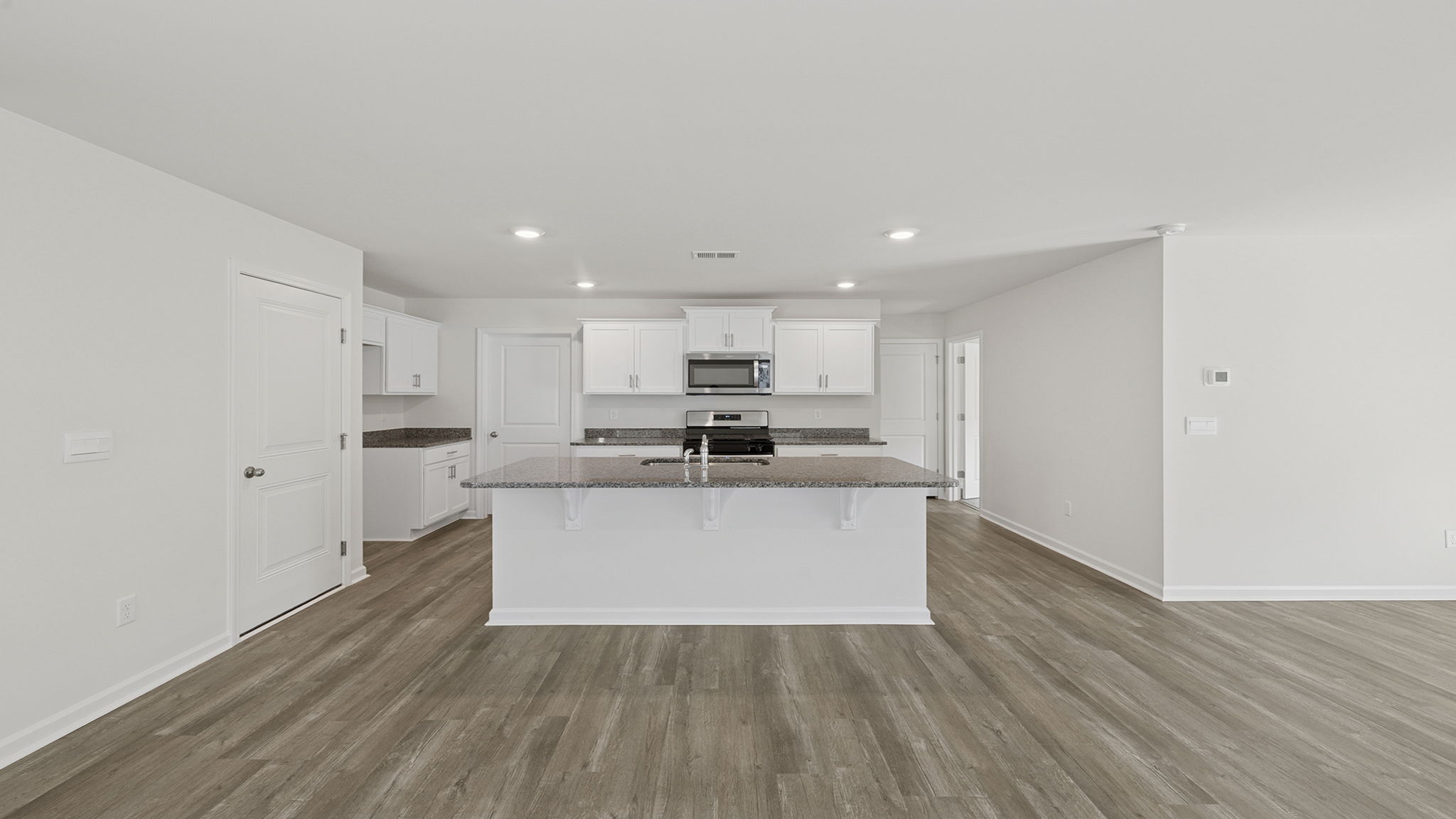 View of open kitchen with quartz counter tops.
