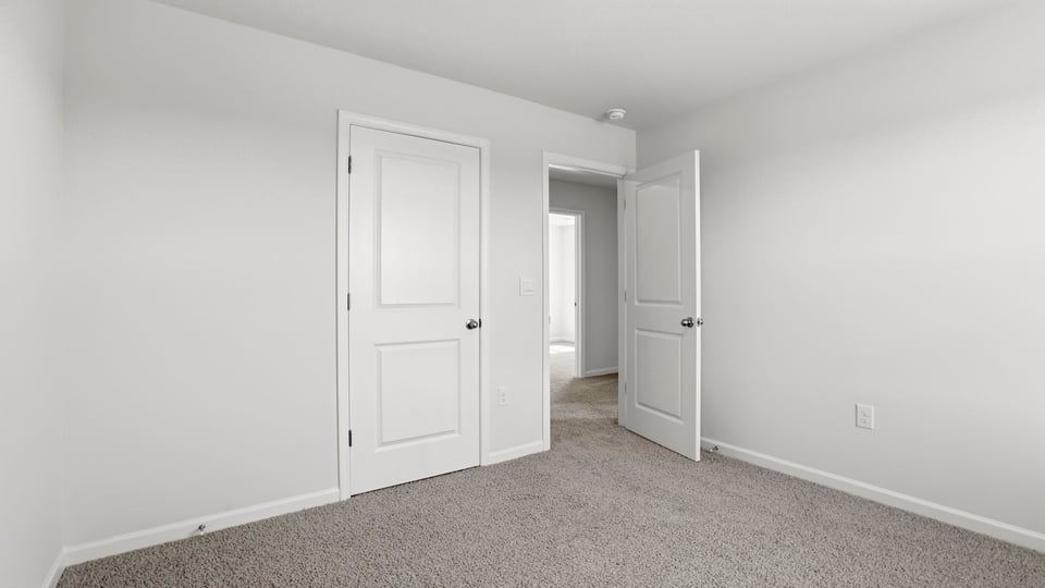 Bedroom with carpet and windows.