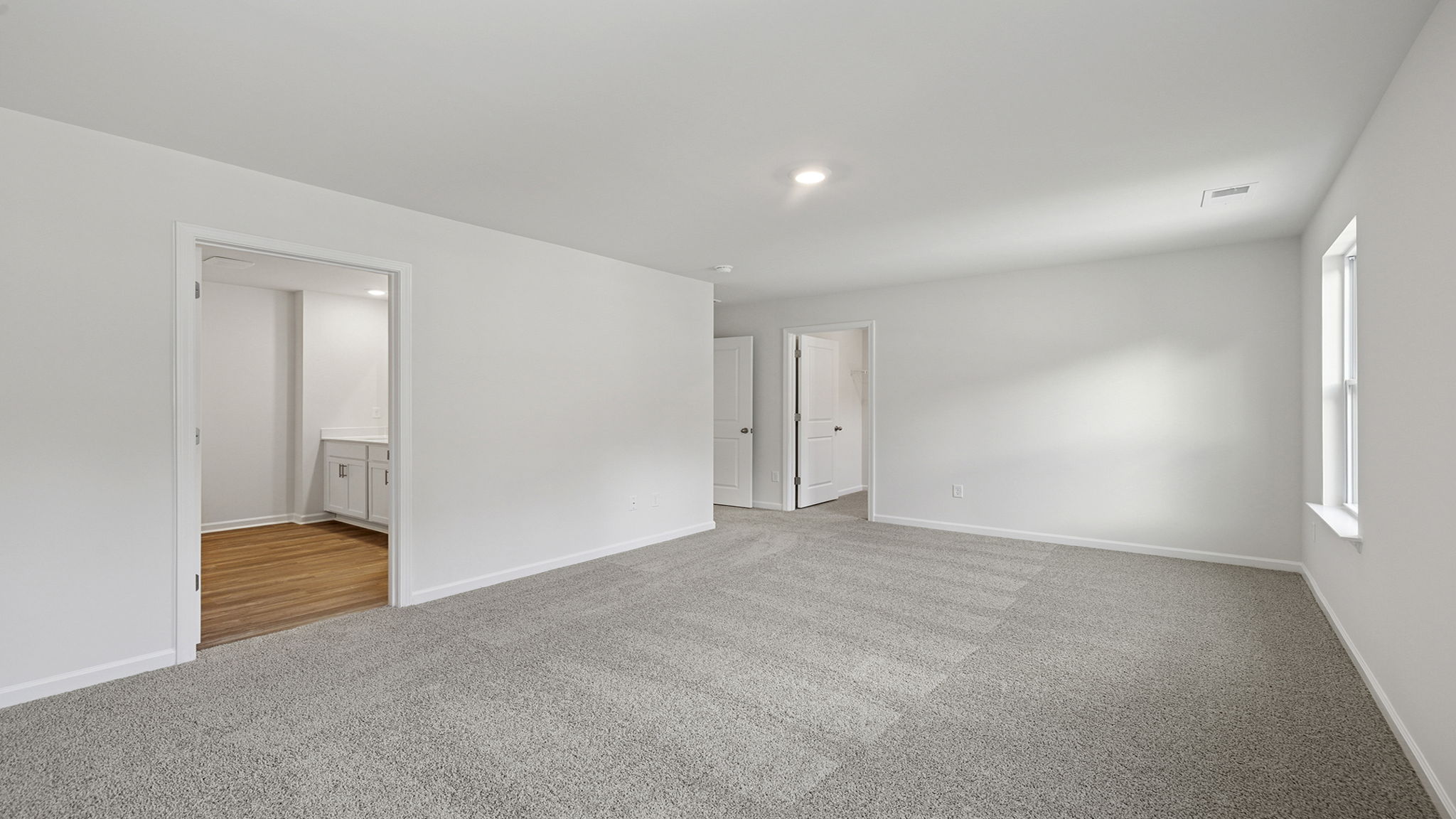 Primary bedroom with large window.