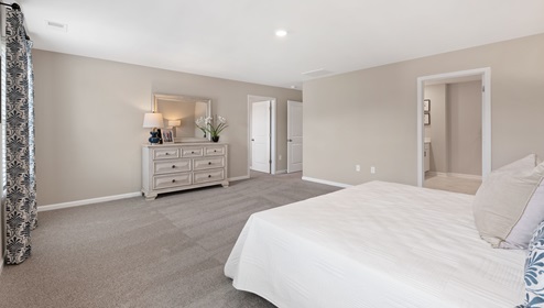 Bedroom with carpet and window.