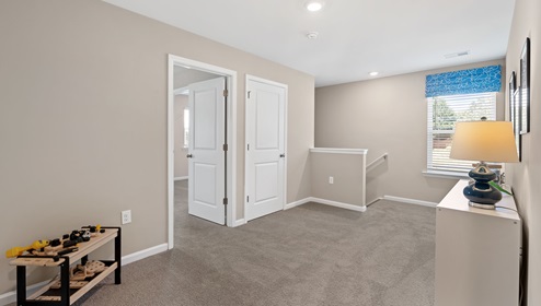 Loft area with carpet and window.