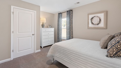 Bedroom with carpet and window.