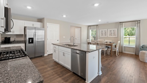 Kitchen and island with granite counter tops.