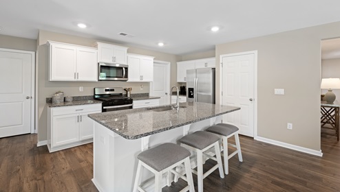Kitchen and island with granite counter tops.
