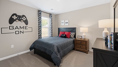 Bedroom with carpet and window.