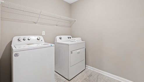 Laundry room with hanging storage racks.