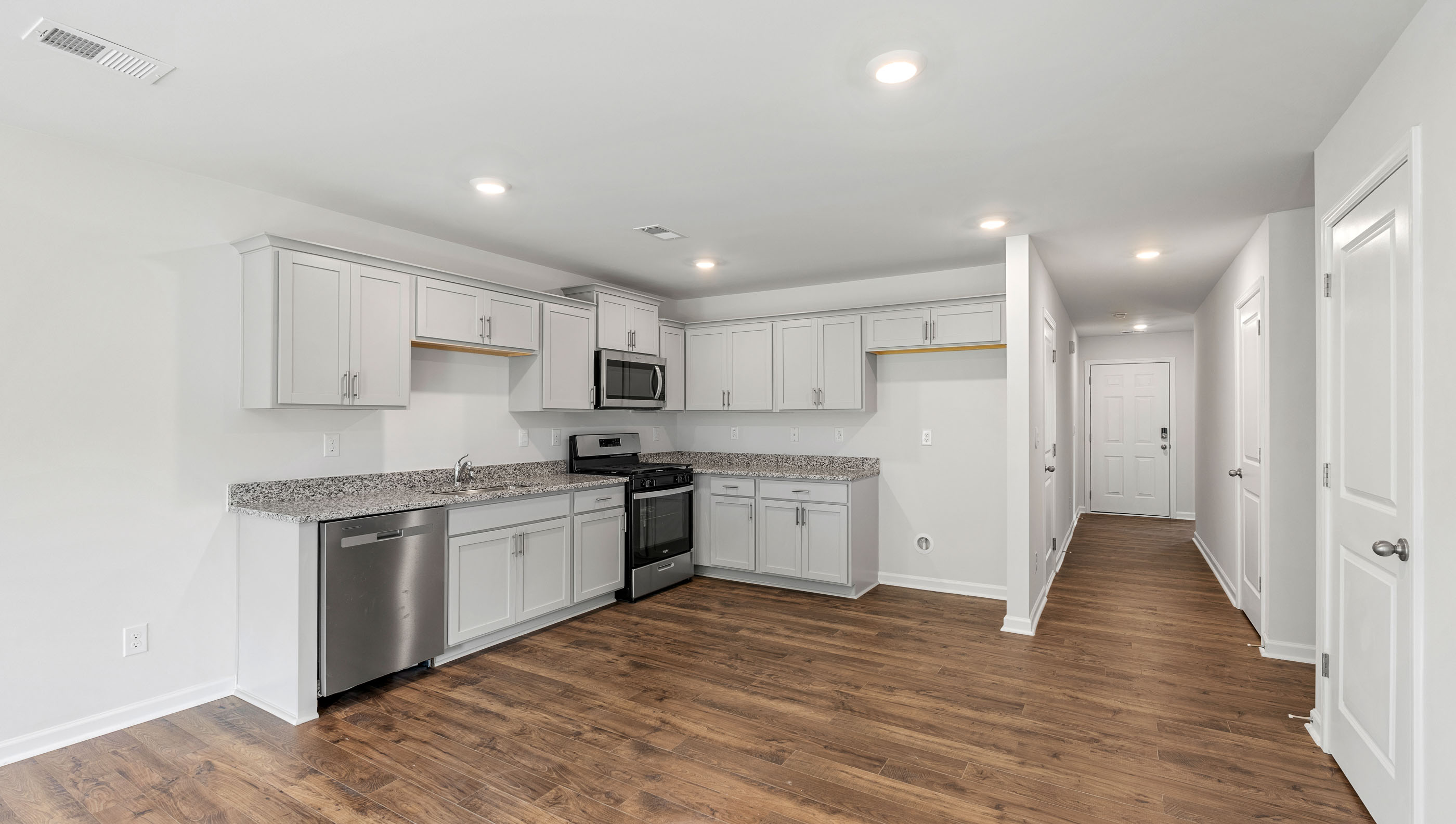 Kitchen and island with granite counter tops.