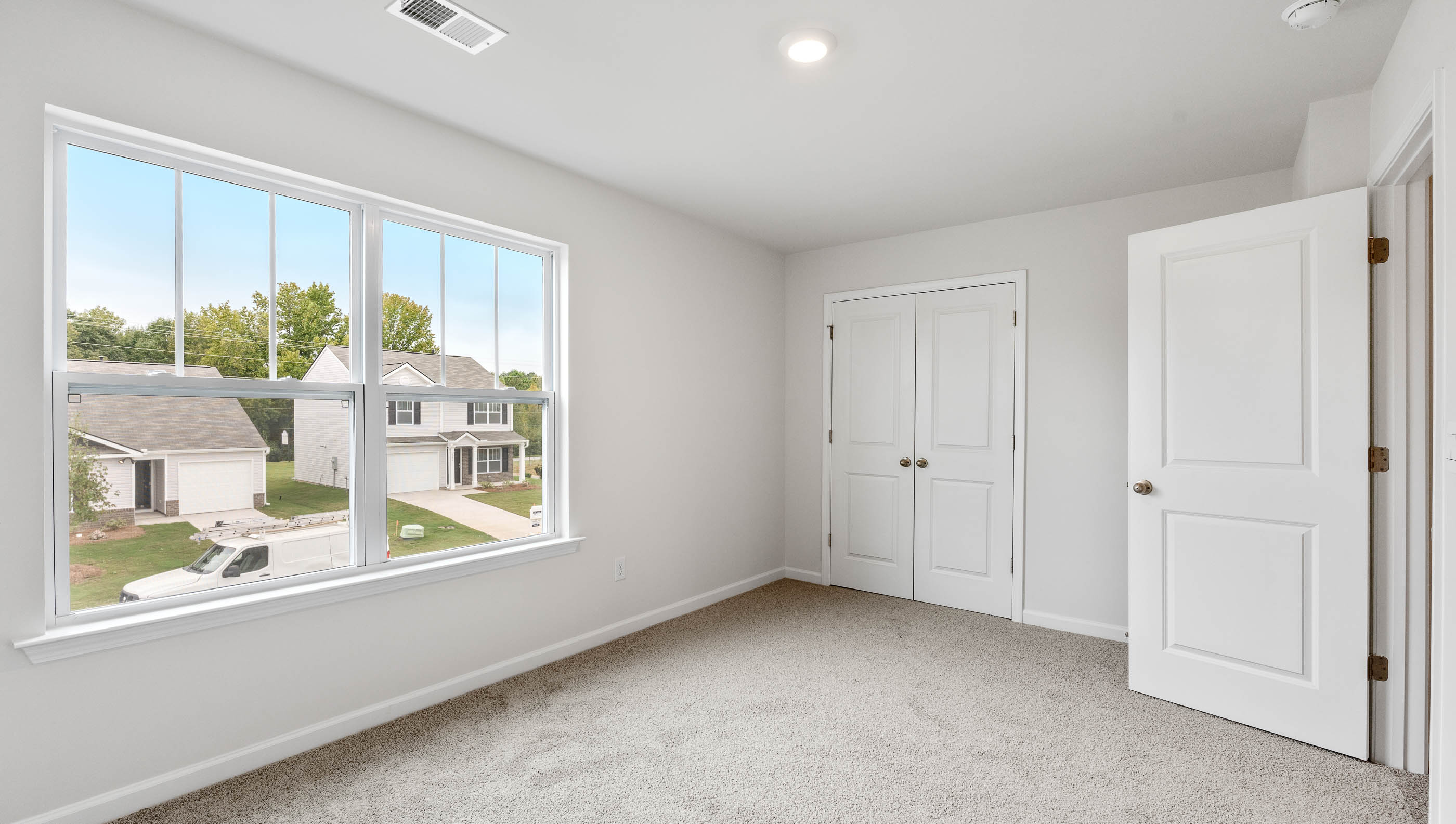 Bedroom with window and carpet.