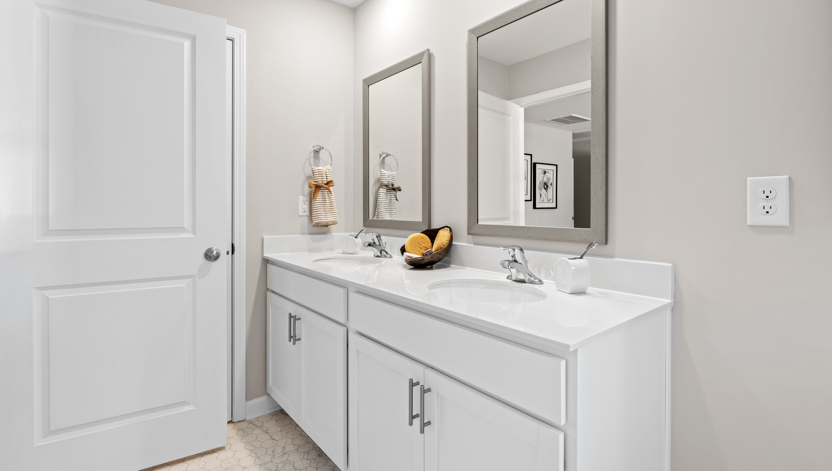 Primary bathroom with double vanities.