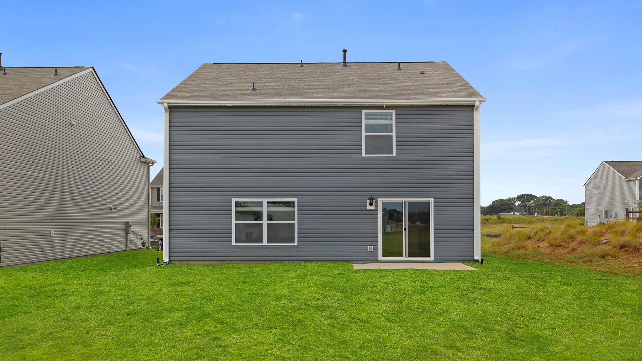 Back exterior view of home and patio.