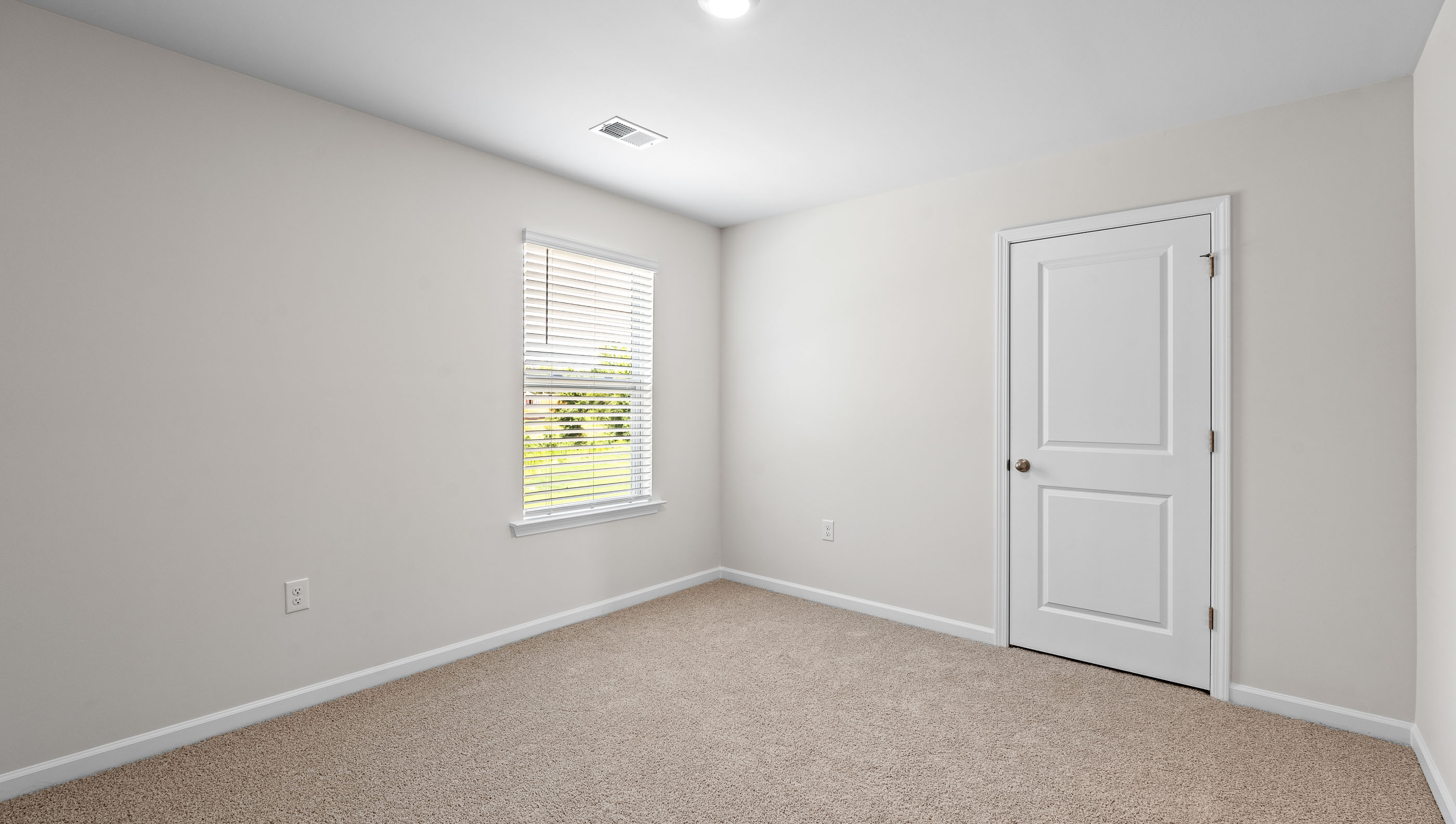 Bedroom with carpet and window.