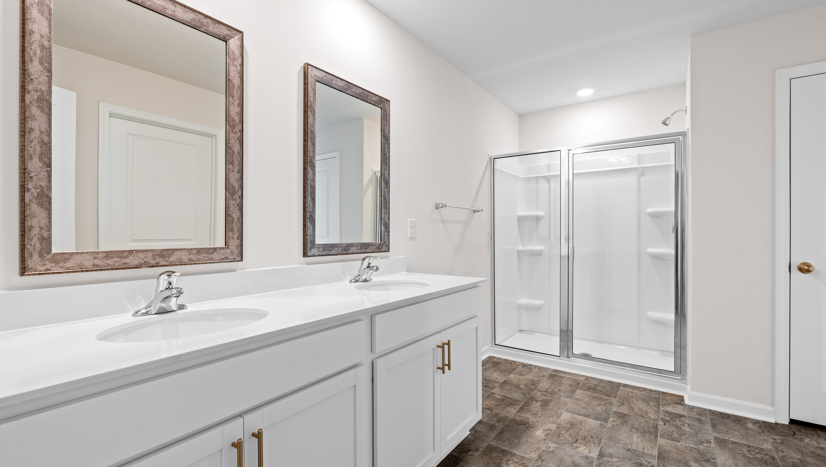 Primary bathroom with double vanities.