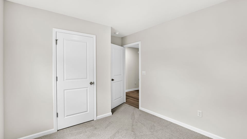 Bedroom with carpet and window.