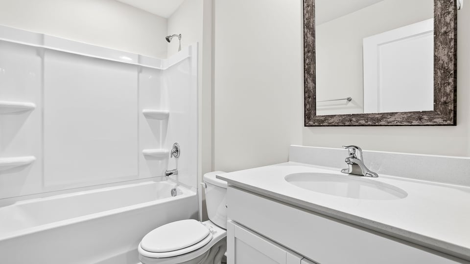 Bathroom with single vanity sink and bathtub.