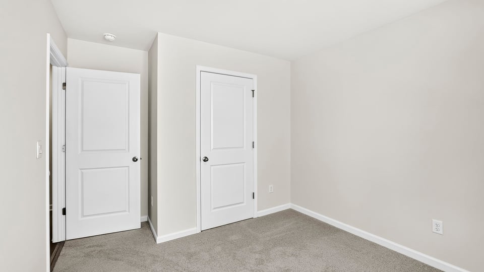 Bedroom with carpet and window.