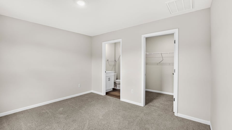 Bedroom with carpet and window.