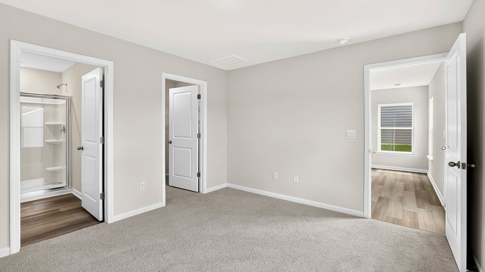 Bedroom with carpet and window.