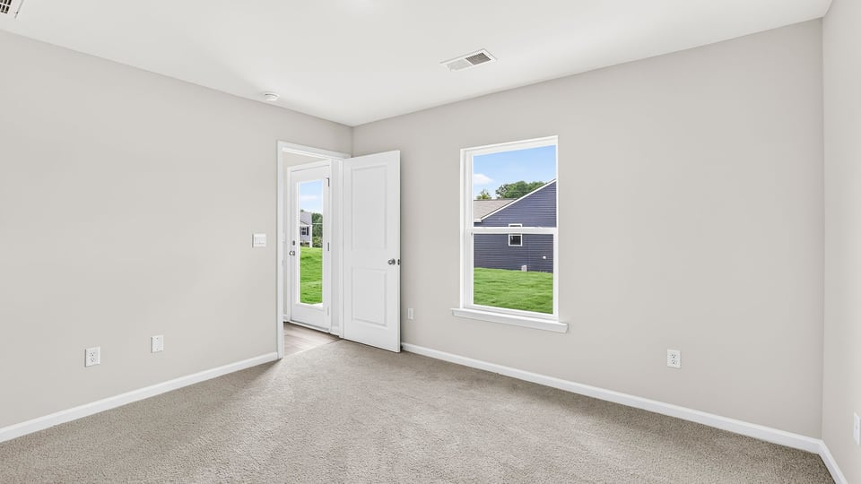 Bedroom with carpet and window.