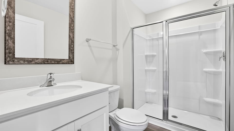 Bathroom with single vanity sink and walk in shower.