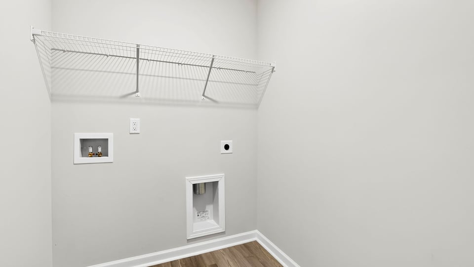 Laundry room with hanging storage racks.