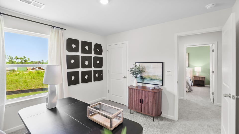 Bedroom with carpet and windows.