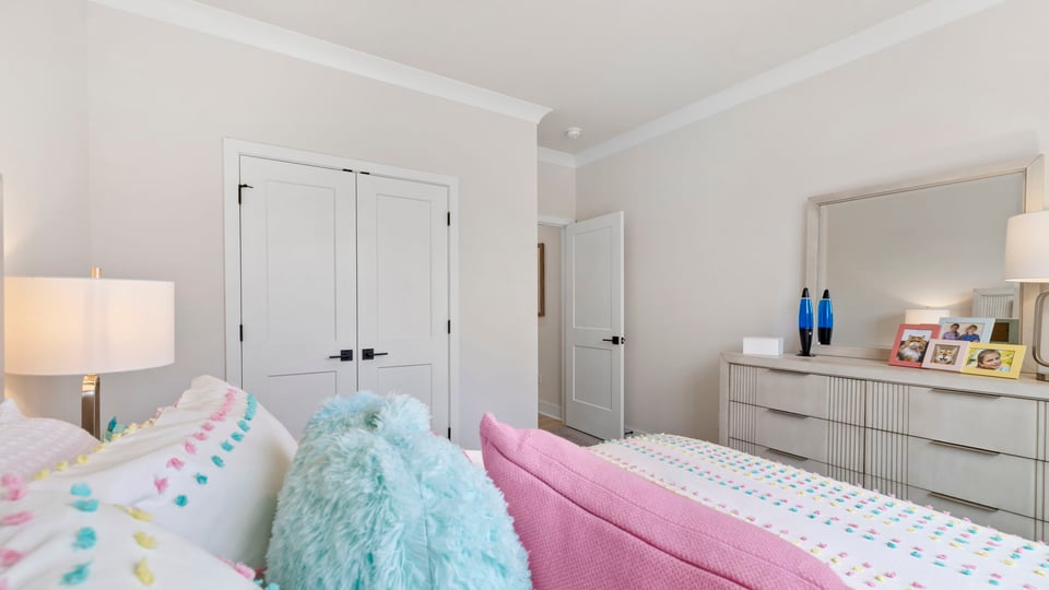 Bedroom with carpet and windows.